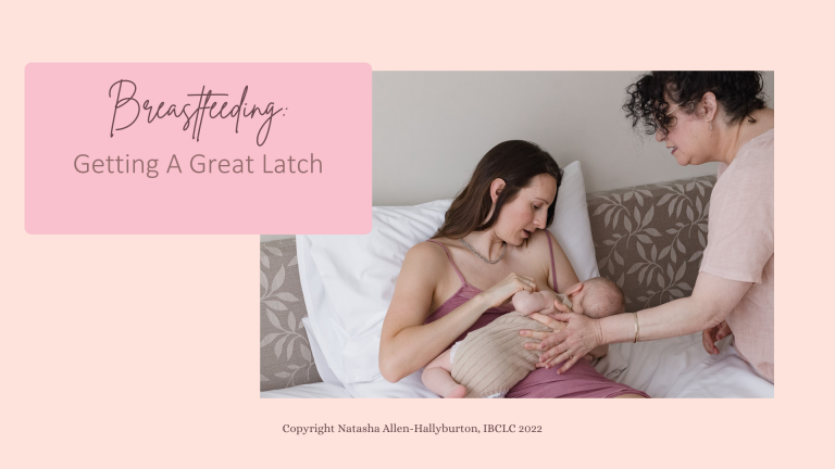 Image of a woman breastfeeding a baby in bed. An older woman guides her hands